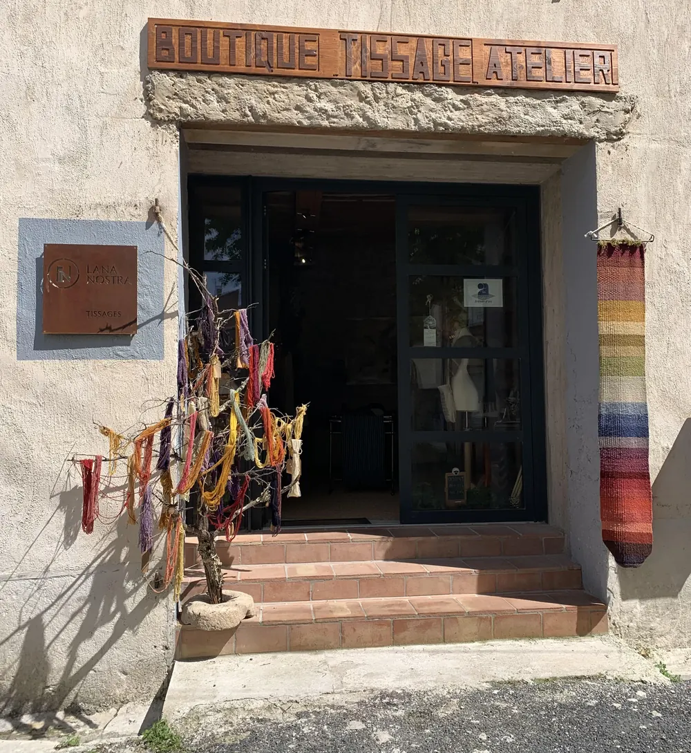 La façade de l'atelier boutique Lana Nostra à Padern, avec des écheveaux de laine teinte à l'entrée